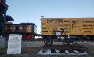 Yellow Union Pacific rail car on train tracks at Trails End