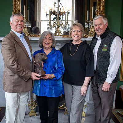 Missouri Ag Hall of Fame Winner with the Trophy and Governor Parson