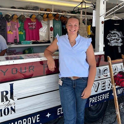 Molly Prichard standing outside the Missouri State Fair Foundation Souvenir Trailer at the Missouri State Fair