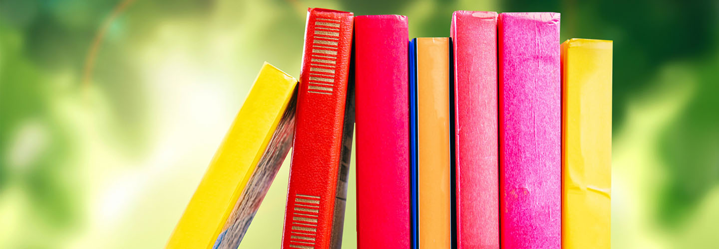 A stack of books on a table outside