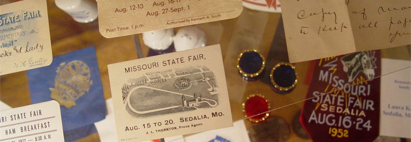 A case full of historical items from previous fairs in the State Fair Museum