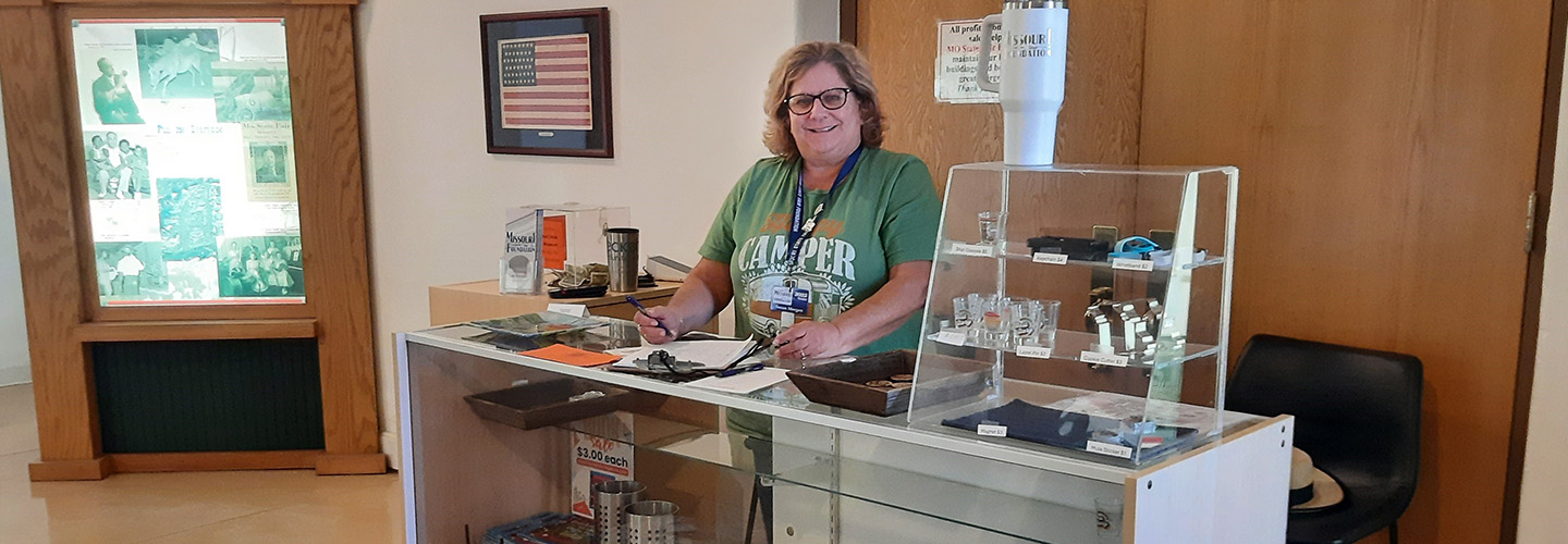 A volunteer standing behind the counter at the state fair museum