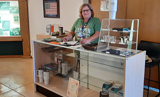 A volunteer standing behind the counter at the state fair museum