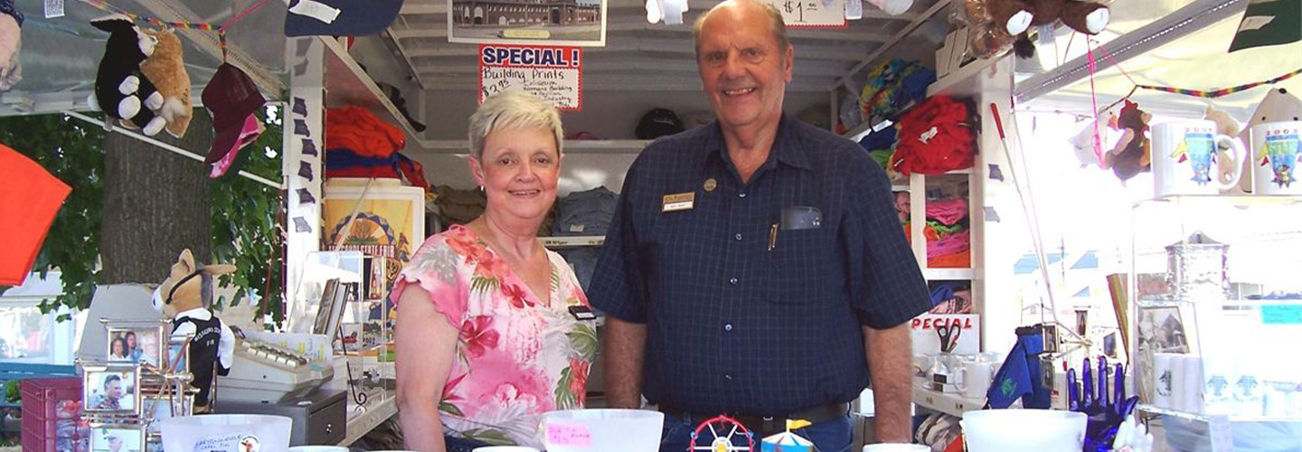 Two volunteers selling items at the fair